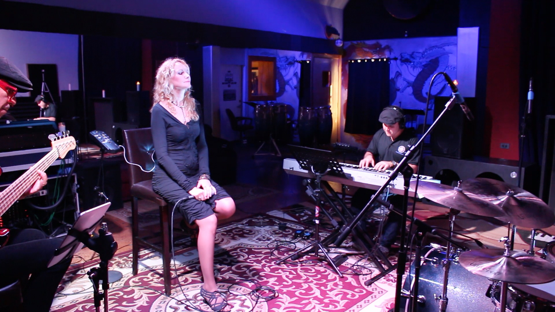 Juliana Polansky singing live with a band in a recording studio