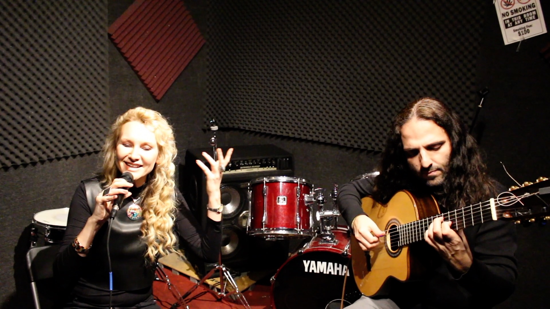 Juliana Polansky singing with a guitarist during a recording session