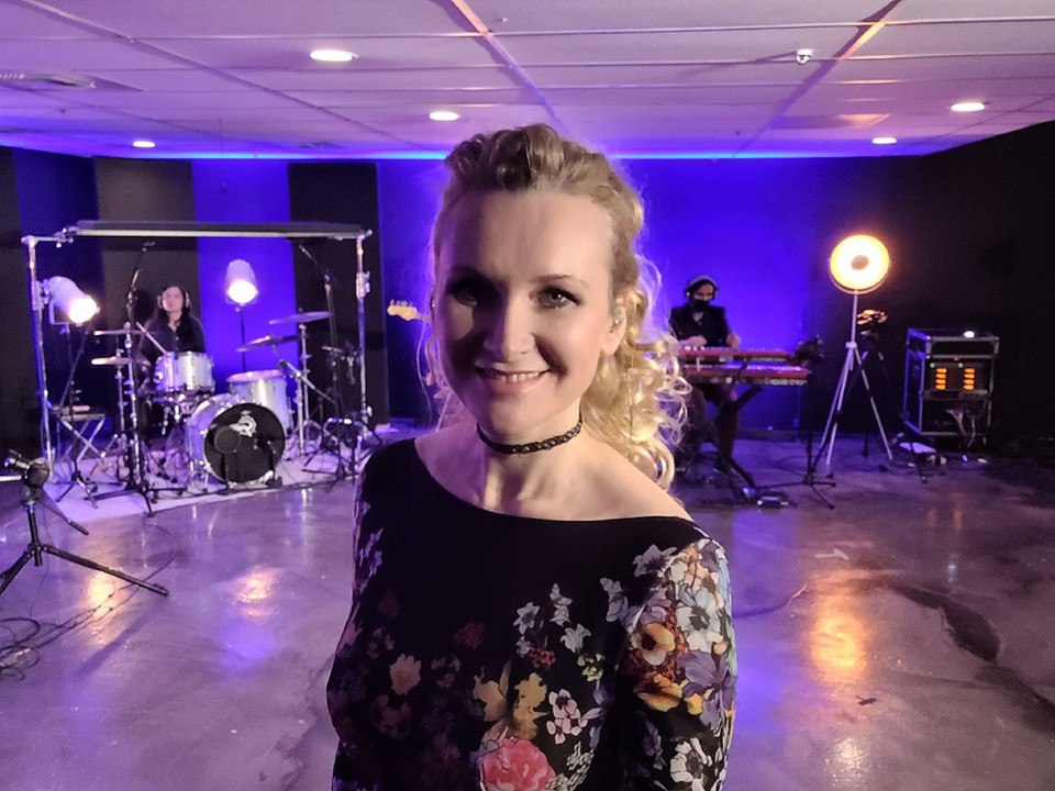 Live concert performance with a microphone under stage lighting